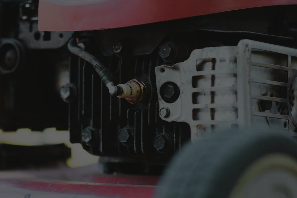 A close up of the engine of a lawn mower