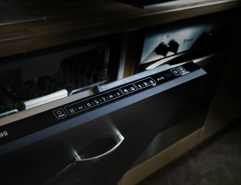 A modern samsung dishwasher drawer built into cabinetry.